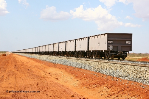 02256 080124 1621
Chapman Siding, view looking north of a rake of new CSR Zhuzhou Rolling Stock Works China built waggons stabled in the passing track to free up yard room. 24th January 2008.
Keywords: 2256;CSR-Zhuzhou-Rolling-Stock-Works-China;FMG-ore-waggon;