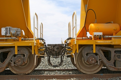 BH. 081225 0576
Barker Siding, view of two of FMG's ballast waggons F type couplings, electric and air connections with the separate air connection for unloading installed. 100 tonne capacity, built in China by CSR at the Yangtze Rolling Stock Company in 2008. December 25, 2008.
Keywords: CSR-Yangtze-Rolling-Stock-Co-China;FMG-ballast-waggon;