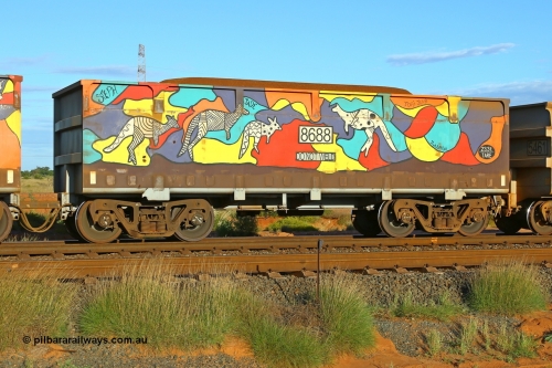 07687-08688 200412 6178
Boodarie, part of a loaded FMG train, painted ore waggon pair 7687 - 8688 built by CRRC Yangtze Rolling Stock Co. of China in 2018, 8688 waggon view, it features mural painting by students of South Hedland High School and was painted in August 2018. April 12, 2020.
Keywords: 7687-8688;CRRC-Yangtze-China;FMG-ore-waggon;
