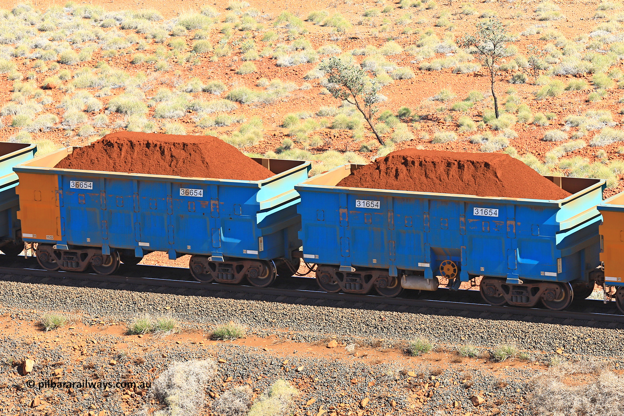 240701 2389
Western Creek, 67 km, one of Rio Tinto's blue rakes with spring assisted park brake and only electronic controlled pneumatic [ECP] braking, waggon pair 31654 is a master and is bar coupled to slave waggon 36654 built by China Northen as a Q type in 11/2022. Captured on July 1, 2024.
Keywords: 31654;36654;Q-type;China-Northern;Rio-ore-waggon;