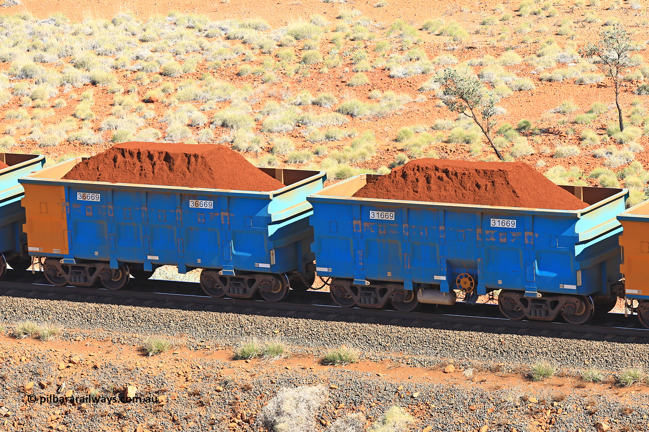 240701 2392
Western Creek, 67 km, one of Rio Tinto's blue rakes with spring assisted park brake and only electronic controlled pneumatic [ECP] braking, waggon pair 31669 is a master and is bar coupled to slave waggon 36669 built by China Northen as a Q type in 11/2022. Captured on July 1, 2024.
Keywords: 31669;36669;Q-type;China-Northern;Rio-ore-waggon;
