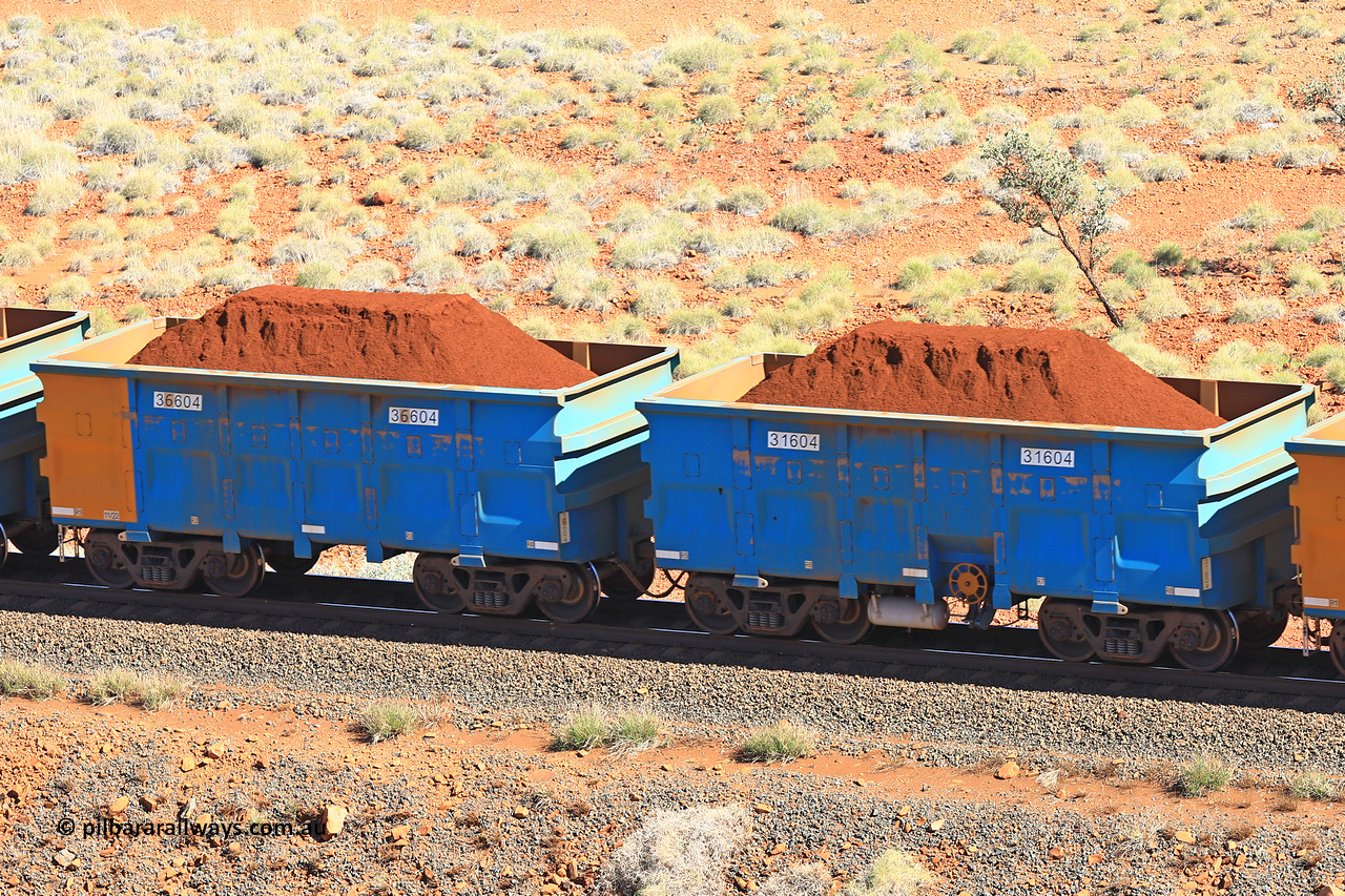 240701 2401
Western Creek, 67 km, one of Rio Tinto's blue rakes with spring assisted park brake and only electronic controlled pneumatic [ECP] braking, waggon pair 31604 is a master and is bar coupled to slave waggon 36604 built by China Northen as a Q type in 11/2022. Captured on July 1, 2024.
Keywords: 31604;36604;Q-type;China-Northern;Rio-ore-waggon;