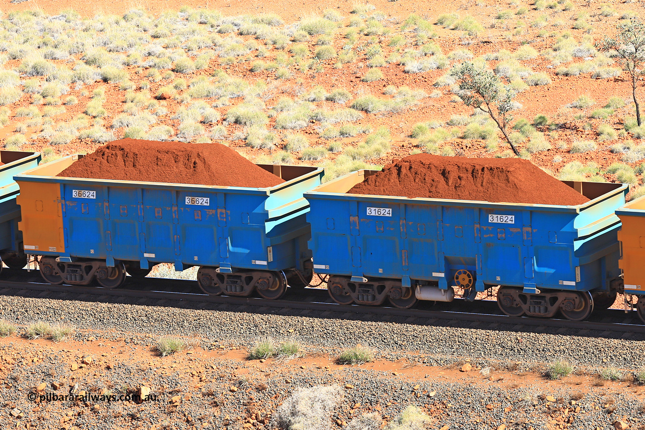 240701 2413
Western Creek, 67 km, one of Rio Tinto's blue rakes with spring assisted park brake and only electronic controlled pneumatic [ECP] braking, waggon pair 31624 is a master and is bar coupled to slave waggon 36624 built by China Northen as a Q type in 11/2022. Captured on July 1, 2024.
Keywords: 31624;36624;Q-type;China-Northern;Rio-ore-waggon;