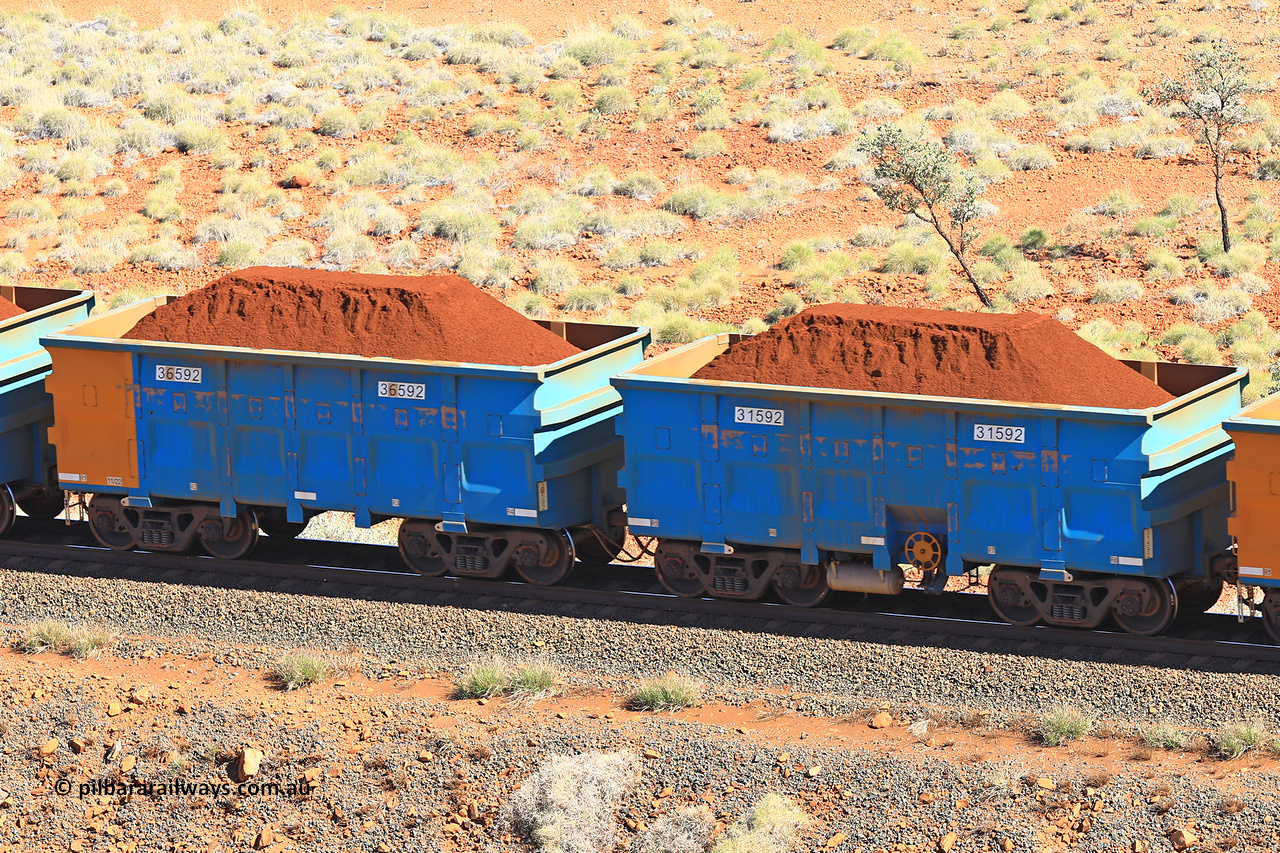 240701 2430
Western Creek, 67 km, one of Rio Tinto's blue rakes with spring assisted park brake and only electronic controlled pneumatic [ECP] braking, waggon pair 31592 is a master and is bar coupled to slave waggon 36592 built by China Northen as a Q type in 11/2022. Captured on July 1, 2024.
Keywords: 31592;36592;Q-type;China-Northern;Rio-ore-waggon;