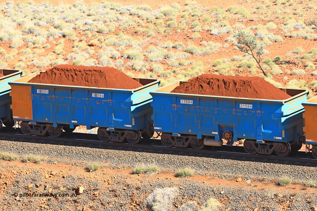 240701 2431
Western Creek, 67 km, one of Rio Tinto's blue rakes with spring assisted park brake and only electronic controlled pneumatic [ECP] braking, waggon pair 31594 is a master and is bar coupled to slave waggon 36594 built by China Northen as a Q type in 11/2022. Captured on July 1, 2024.
Keywords: 31594;36594;Q-type;China-Northern;Rio-ore-waggon;