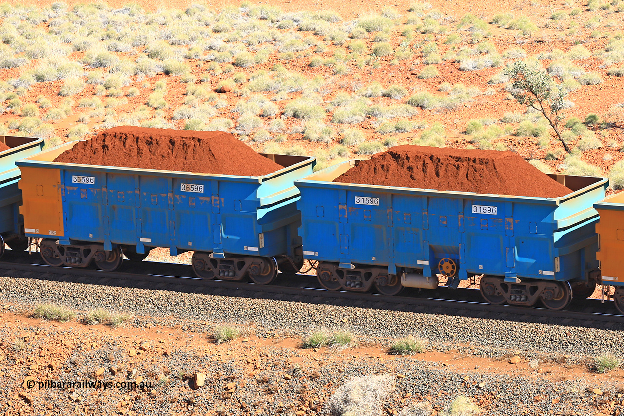 240701 2432
Western Creek, 67 km, one of Rio Tinto's blue rakes with spring assisted park brake and only electronic controlled pneumatic [ECP] braking, waggon pair 31596 is a master and is bar coupled to slave waggon 36596 built by China Northen as a Q type in 11/2022. Captured on July 1, 2024.
Keywords: 31596;36596;Q-type;China-Northern;Rio-ore-waggon;