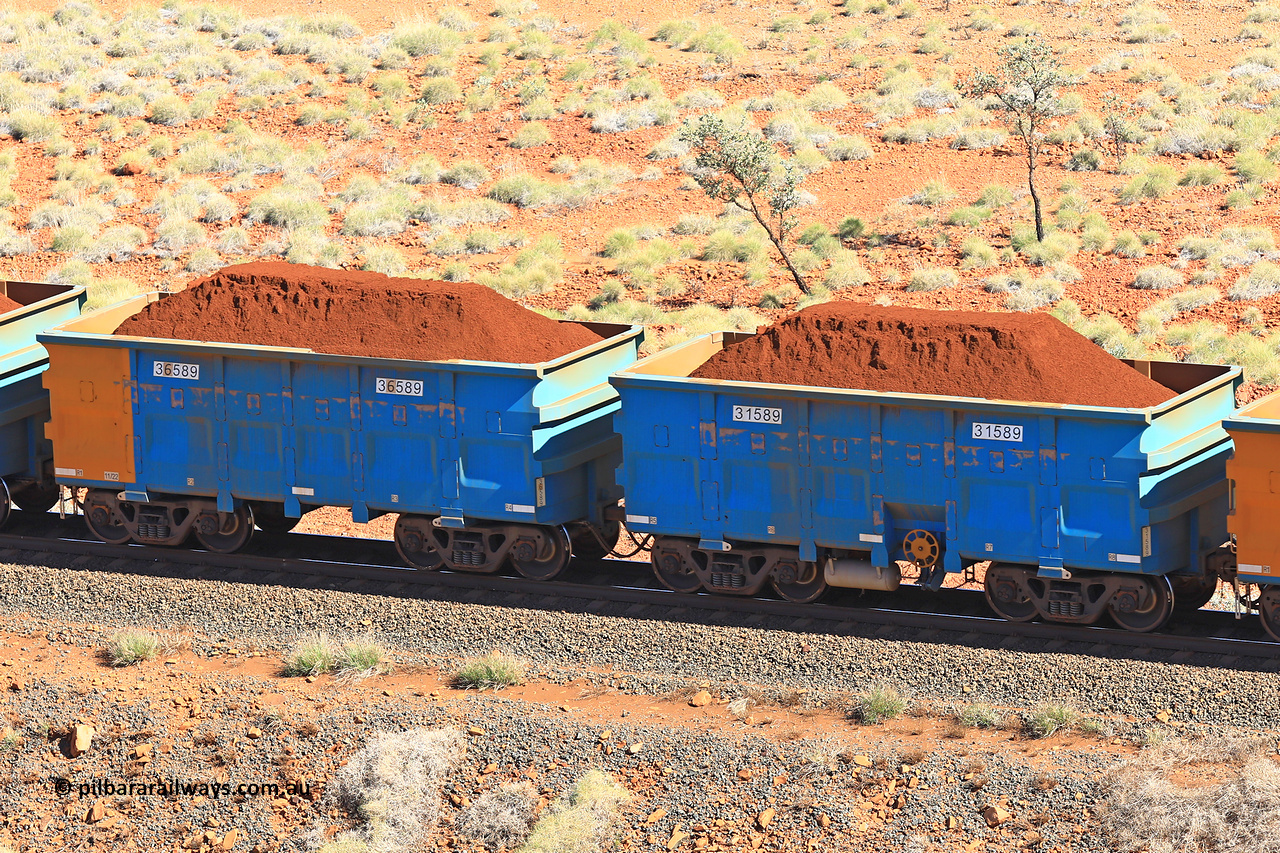 240701 2435
Western Creek, 67 km, one of Rio Tinto's blue rakes with spring assisted park brake and only electronic controlled pneumatic [ECP] braking, waggon pair 31589 is a master and is bar coupled to slave waggon 36589 built by China Northen as a Q type in 11/2022. Captured on July 1, 2024.
Keywords: 31589;36589;Q-type;China-Northern;Rio-ore-waggon;