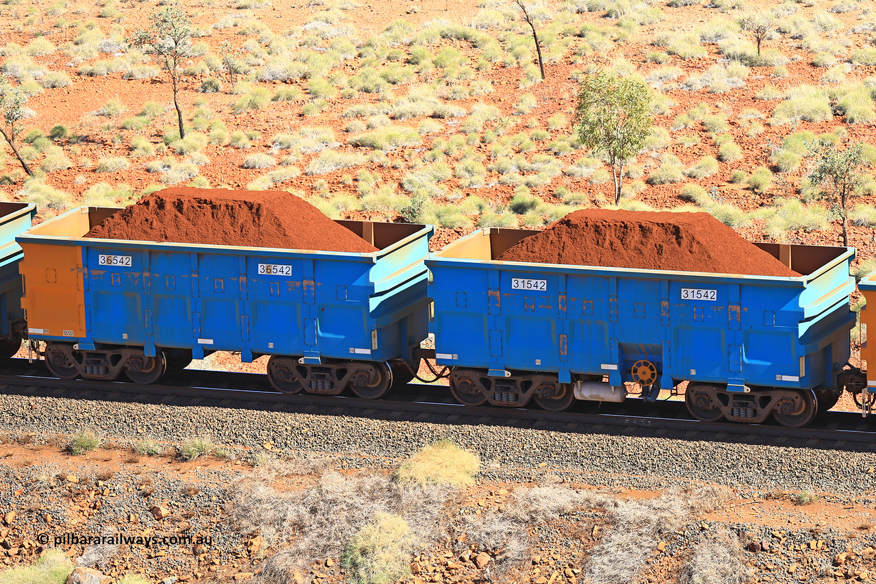 240701 2447
Western Creek, 67 km, one of Rio Tinto's blue rakes with spring assisted park brake and only electronic controlled pneumatic [ECP] braking, waggon pair 31542 is a master and is bar coupled to slave waggon 36542 built by China Northen as a Q type in 12/2022. Captured on July 1, 2024.
Keywords: 31542;36542;Q-type;China-Northern;Rio-ore-waggon;