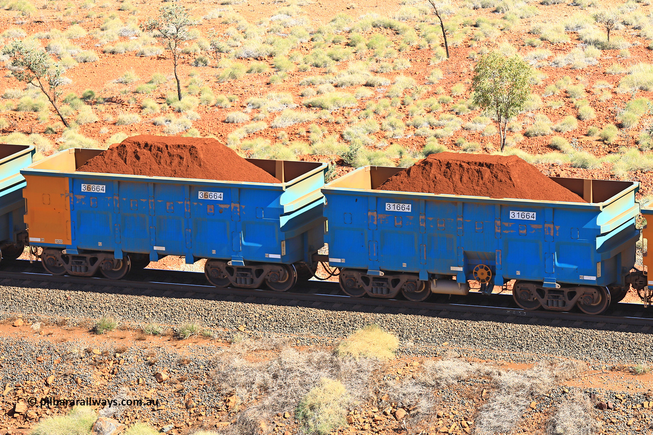 240701 2457
Western Creek, 67 km, one of Rio Tinto's blue rakes with spring assisted park brake and only electronic controlled pneumatic [ECP] braking, waggon pair 31664 is a master and is bar coupled to slave waggon 36664 built by China Northen as a Q type in 11/2022. Captured on July 1, 2024.
Keywords: 31664;36664;Q-type;China-Northern;Rio-ore-waggon;