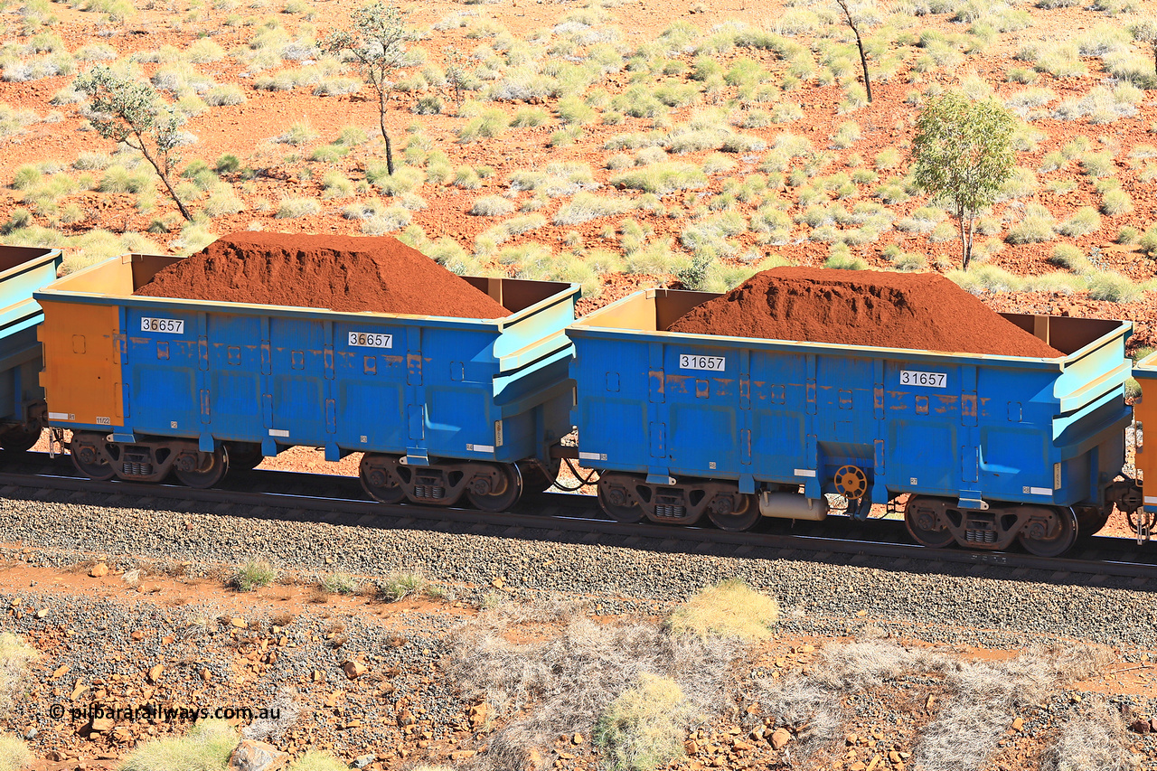 240701 2462
Western Creek, 67 km, one of Rio Tinto's blue rakes with spring assisted park brake and only electronic controlled pneumatic [ECP] braking, waggon pair 31657 is a master and is bar coupled to slave waggon 36657 built by China Northen as a Q type in 11/2022. Captured on July 1, 2024.
Keywords: 31657;36657;Q-type;China-Northern;Rio-ore-waggon;
