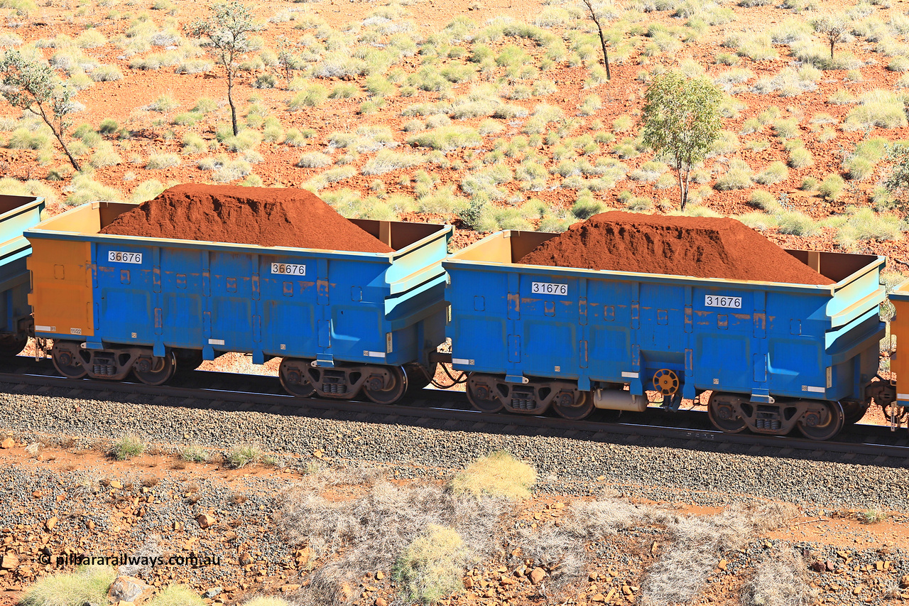 240701 2463
Western Creek, 67 km, one of Rio Tinto's blue rakes with spring assisted park brake and only electronic controlled pneumatic [ECP] braking, waggon pair 31676 is a master and is bar coupled to slave waggon 36676 built by China Northen as a Q type in 11/2022. Captured on July 1, 2024.
Keywords: 31676;36676;Q-type;China-Northern;Rio-ore-waggon;