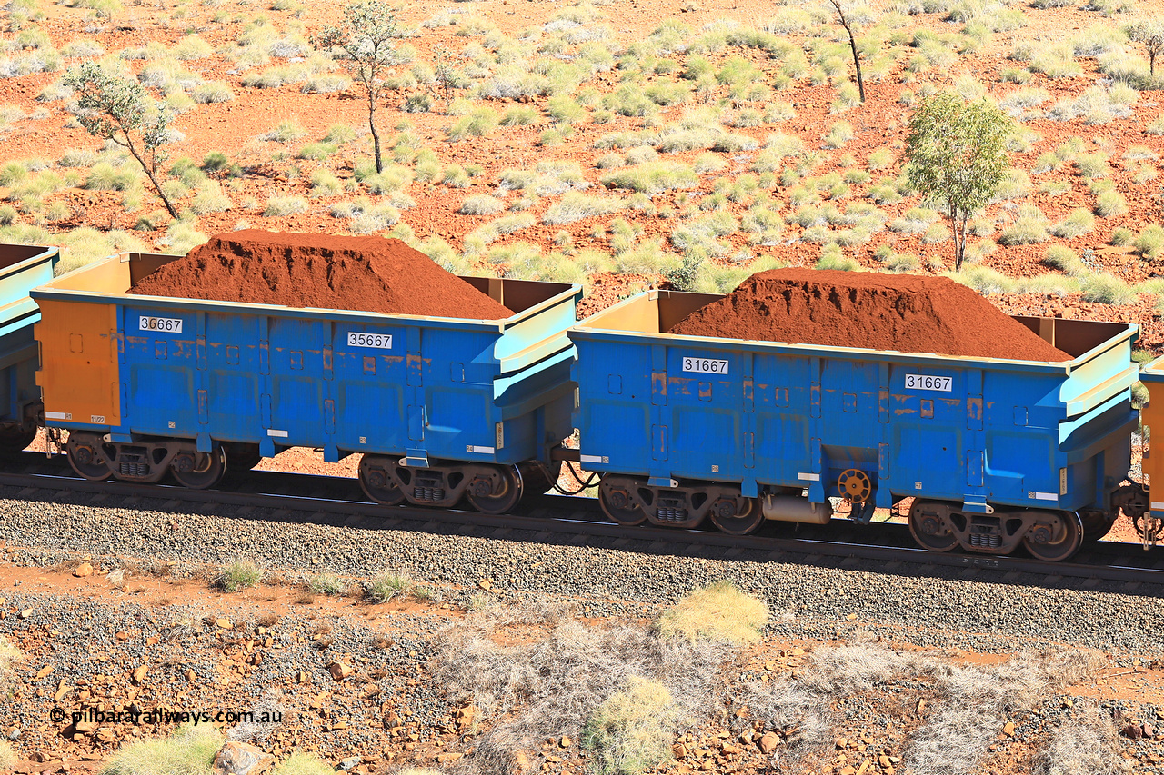 240701 2464
Western Creek, 67 km, one of Rio Tinto's blue rakes with spring assisted park brake and only electronic controlled pneumatic [ECP] braking, waggon pair 31667 is a master and is bar coupled to slave waggon 36667 built by China Northen as a Q type in 11/2022. Captured on July 1, 2024.
Keywords: 31667;36667;Q-type;China-Northern;Rio-ore-waggon;