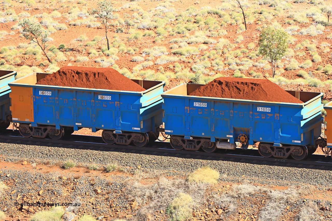240701 2465
Western Creek, 67 km, one of Rio Tinto's blue rakes with spring assisted park brake and only electronic controlled pneumatic [ECP] braking, waggon pair 31659 is a master and is bar coupled to slave waggon 36659 built by China Northen as a Q type in 11/2022. Captured on July 1, 2024.
Keywords: 31659;36659;Q-type;China-Northern;Rio-ore-waggon;