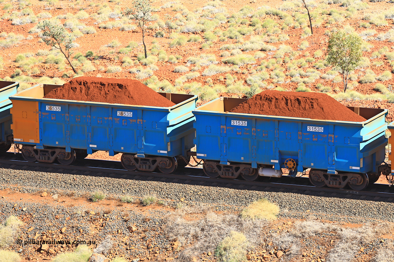 240701 2471
Western Creek, 67 km, one of Rio Tinto's blue rakes with spring assisted park brake and only electronic controlled pneumatic [ECP] braking, waggon pair 31535 is a master and is bar coupled to slave waggon 36535 built by China Northen as a Q type in 12/2022. Captured on July 1, 2024.
Keywords: 31535;36535;Q-type;China-Northern;Rio-ore-waggon;