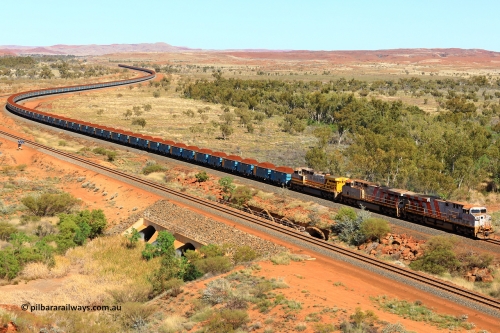 240701 2381
Western Creek, 67 km, Rio Tinto's GE built ES44DCi locomotive 9141 with serial number 64731, delivered in 2018 from the sixth order of this model from GE leads an ES44DCi and 9-44CW locomotives as they snake around the curve between Western Creek and Green Pool with a loaded train of the second rake of blue waggons bound for Cape Lambert. Captured on July 1, 2024.
Keywords: 9141;GE;ES44ACi;64731;