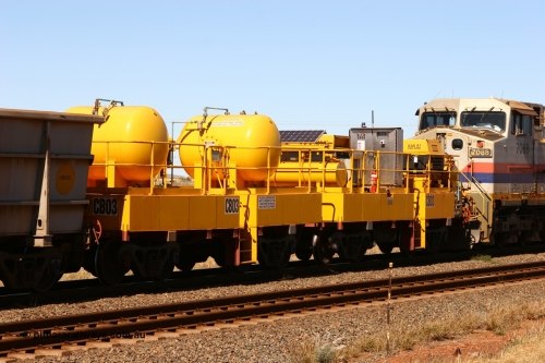 060715 6950
Rio Tinto compressor waggon set CB 03, compressor control waggon with two diesel powered Atlas Copco XAS 97's behind the loco and the receiver waggon with two air tanks or receivers closet to camera. Note the waggons are cut down ore waggons. Seen here just outside of 7 Mile. 15th July 2006.
Keywords: CB03;rio-compressor-waggon;