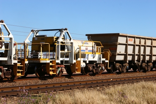 060724 7865
Original Hamersley Iron compressor waggon set IC-1 which were made from cutting down condemned ore waggons and then fitting Atlas Copco XAS 97 air compressors, receiver tanks and fuel tanks. The compressors have been fitted to a swing cradle to limit the in-train forces during the unloading process. 7 Mile 24th July 2006.
Keywords: IC-1;rio-compressor-waggon;
