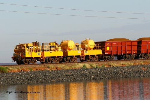 110602 8604
Rio Tinto compressor waggon set CB 04, compressor control waggon with two diesel powered Atlas Copco XAS 97's and the receiver waggon with two air tanks or receivers. Note the waggons are cut down ore waggons. Seen here on the causeway just outside of 7 Mile. 2nd June 2011.
Keywords: CB04;rio-compressor-waggon;