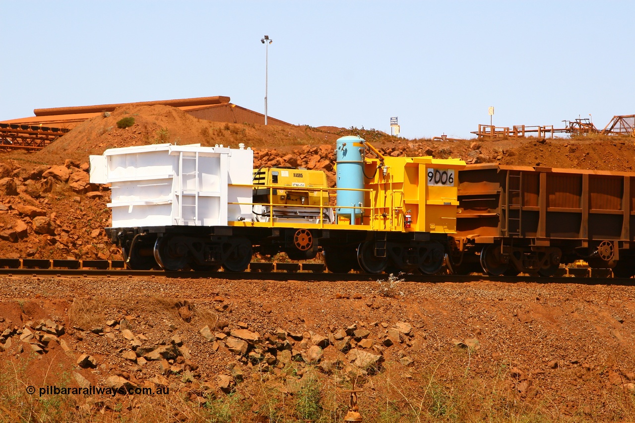 070909 0655
Robe River compressor waggon 9006 on the lead of a Deepdale rake going through the car dumper at Cape Lambert. Fitted with an Atlas Copco XAS 85 compressor, fuel tank and air receiver. This waggon is a modified Tomlinson Steel built ore waggon. 9th August 2007.
Keywords: 9006;robe-compressor-waggon;