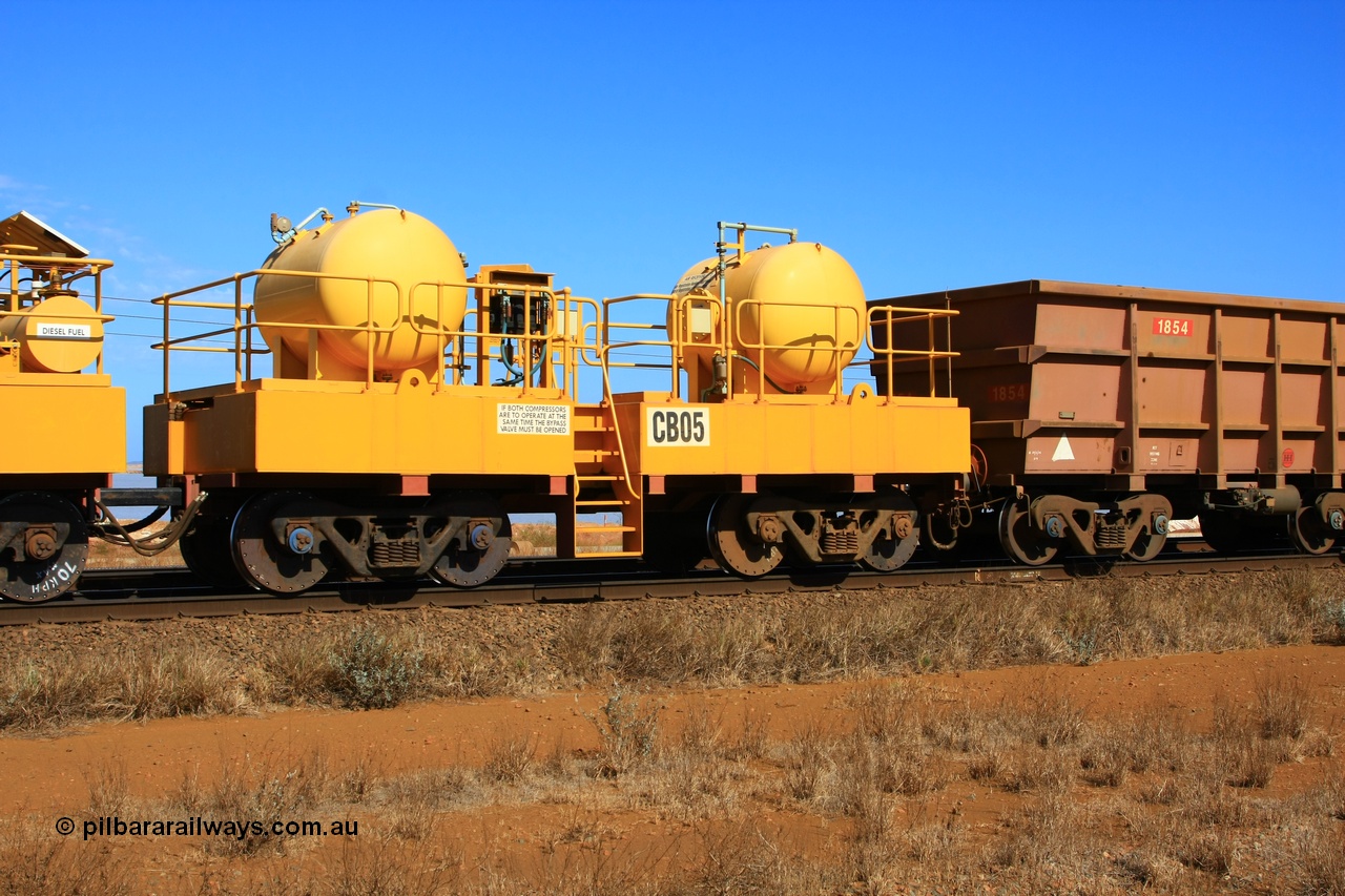 100330 8067
Rio Tinto compressor waggon set CB 05, receiver waggon with two air tanks or receivers. Note the waggons are cut down ore waggons and the wheels are marked 70 kph max. Seen here just outside of 7 Mile. 30th March 2010.
Keywords: CB05;rio-compressor-waggon;