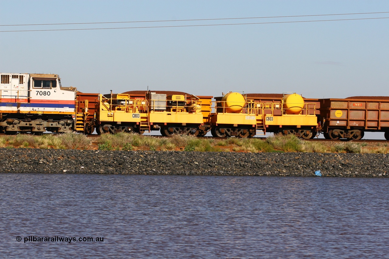110602 8648
Rio Tinto compressor waggon set CB 03, compressor control waggon with two diesel powered Atlas Copco XAS 97's behind the loco and the receiver waggon with two air tanks or receivers. Note the waggons are cut down ore waggons. Seen here on the causeway just outside of 7 Mile. 2nd June 2011.
Keywords: CB03;rio-compressor-waggon;