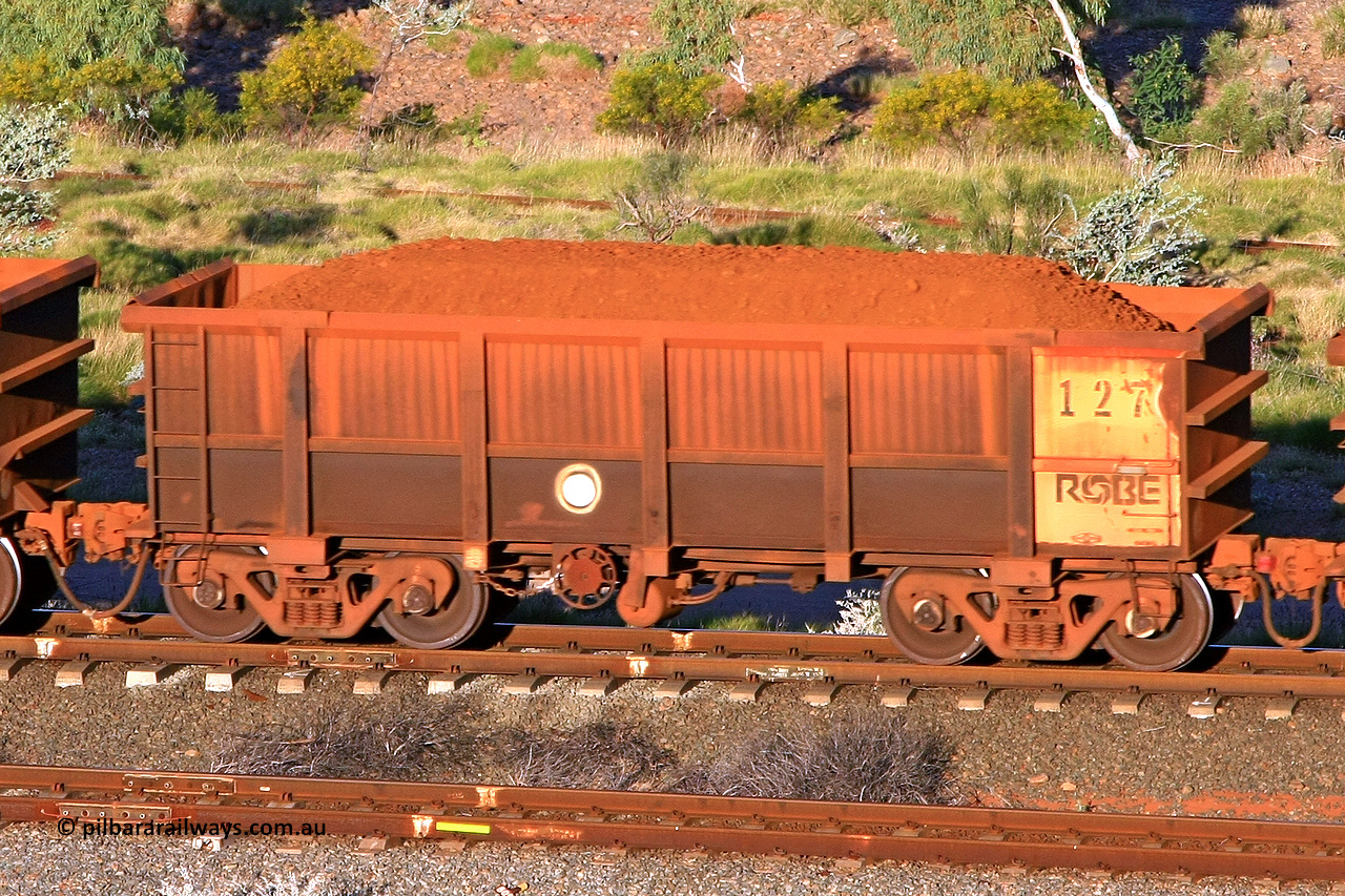 0127 110602 1656
Robe River ore waggon 127, built by Nippon Sharyo Nihon, rotary coupler end handbrake side loaded view at the 71 km, Western Creek on the Deepdale line. June 2, 2011.
Keywords: 127;Nippon-Sharyo-Nihon;Robe-ore-waggon;