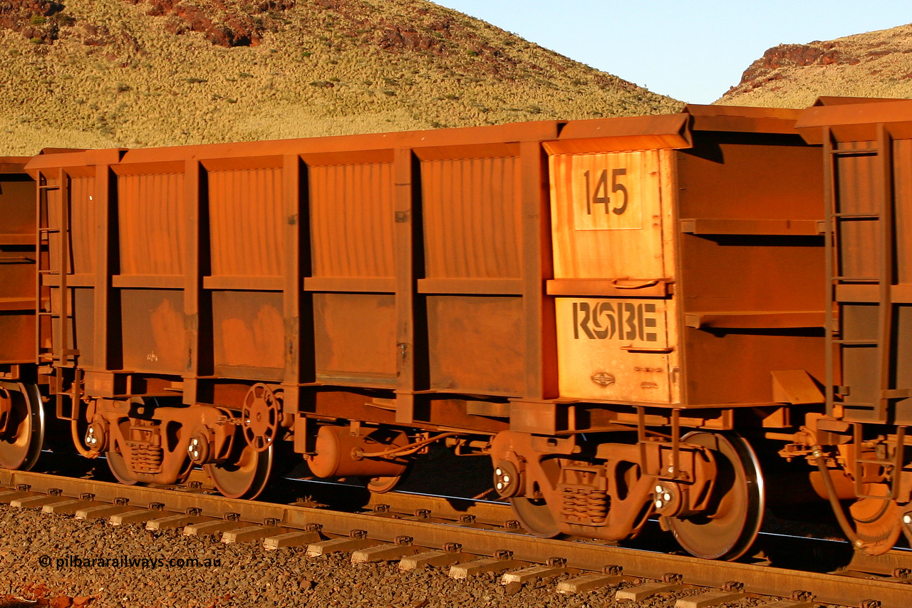 0145 060722 7597
Robe River ore waggon 145, built by Nippon Sharyo Nihon, rotary coupler end handbrake side empty view, at the 11.7 km, Cape Lambert. July 22, 2006.
Keywords: 145;Nippon-Sharyo-Nihon;Robe-ore-waggon;