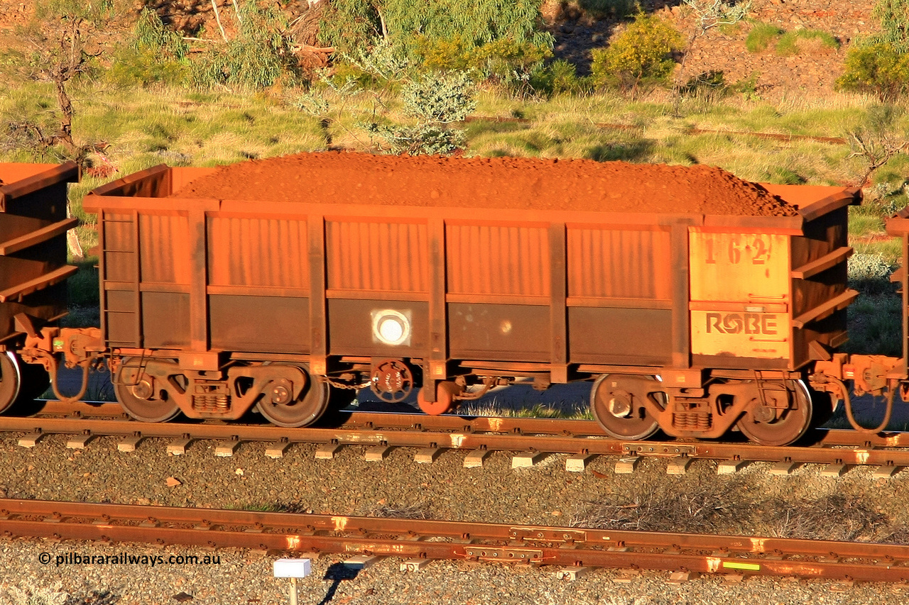 0162 110602 1675
Robe River ore waggon 162, built by Nippon Sharyo Nihon, rotary coupler end handbrake side loaded view at the 71 km, Western Creek on the Deepdale line. June 2, 2011.
Keywords: 162;Nippon-Sharyo-Nihon;Robe-ore-waggon;