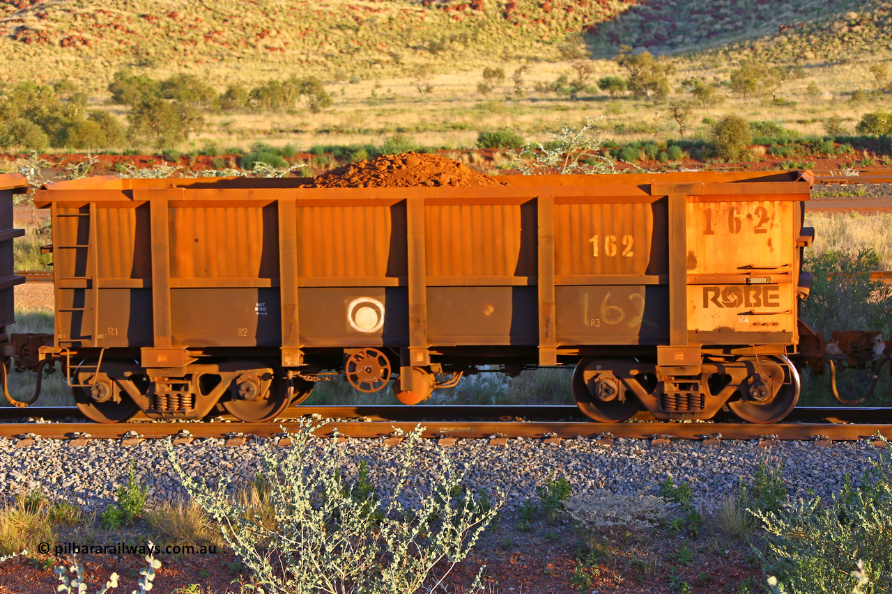 0162 170513 8762
Robe River ore waggon 162, built by Nippon Sharyo Nihon, handbrake side, only partially loaded, view, Cape Lambert yard, May 13, 2017.
Keywords: 162;Nippon-Sharyo-Nihon;Robe-ore-waggon;