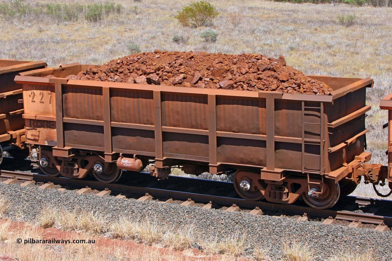 0227 081209 0163
Robe River ore waggon 227, built by Nippon Sharyo Nihon, fixed coupler non-handbrake side loaded view at the 7 km location just south of Cape Lambert yard. December 9, 2008.
Keywords: 227;Nippon-Sharyo-Nihon;Robe-ore-waggon;