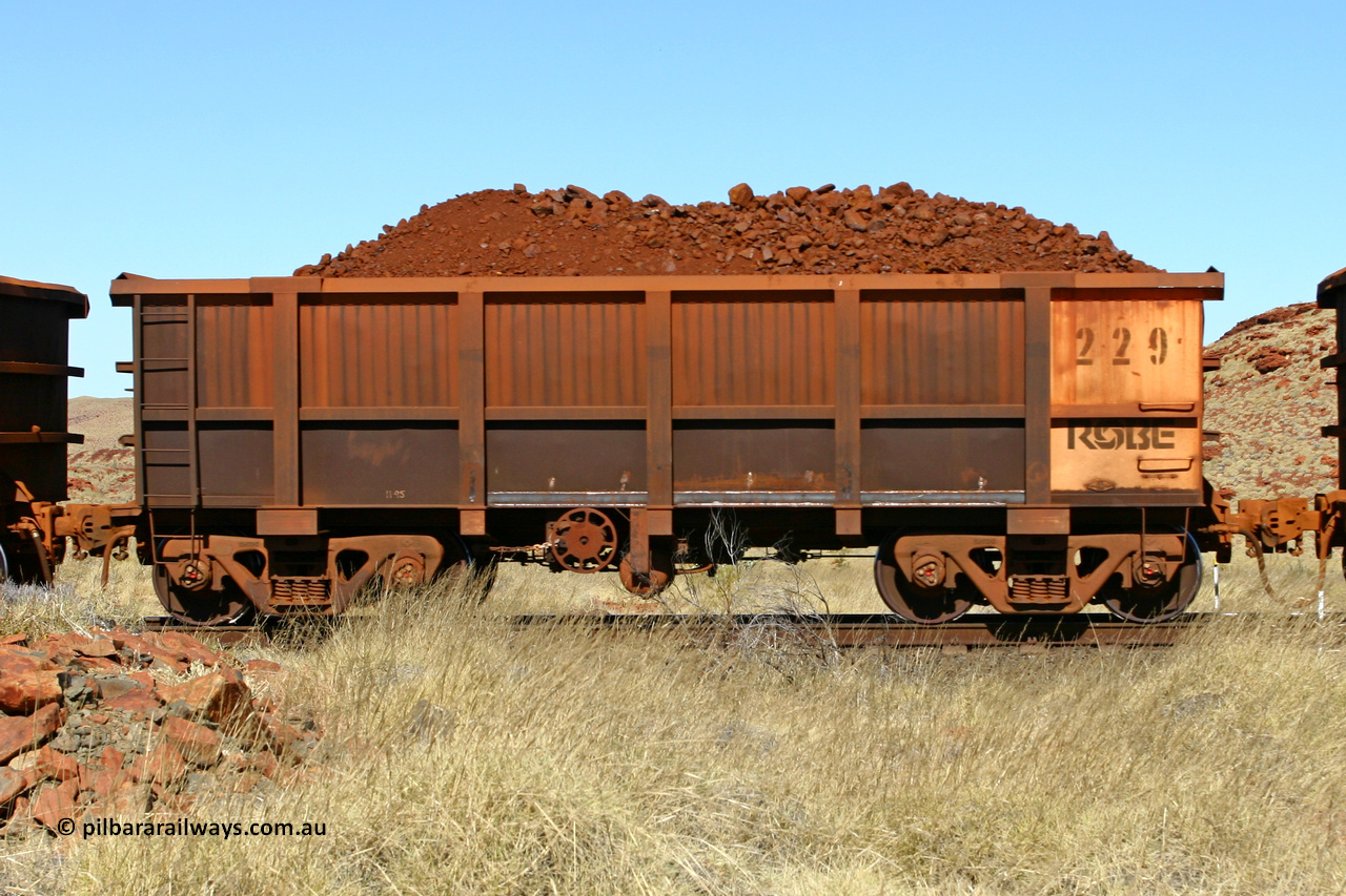 0229 060722 7494
Robe River ore waggon 229, built by Nippon Sharyo Nihon, handbrake side loaded view at the 78.8 km between Western Creek and Maitland on the Deepdale line. July 22, 2006.
Keywords: 229;Nippon-Sharyo-Nihon;Robe-ore-waggon;