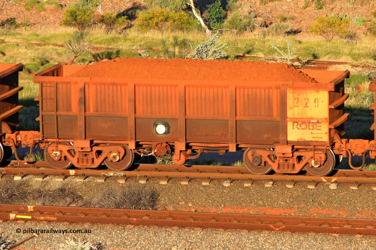 0229 110602 1658
Robe River ore waggon 229, built by Nippon Sharyo Nihon, rotary coupler end handbrake side loaded view at the 71 km, Western Creek on the Deepdale line. June 2, 2011.
Keywords: 229;Nippon-Sharyo-Nihon;Robe-ore-waggon;