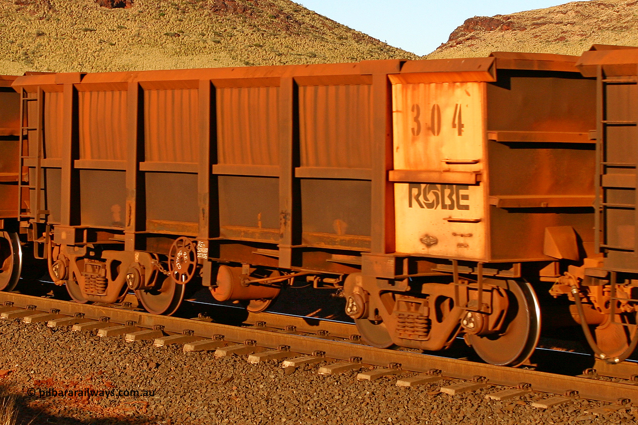 0304 060722 7609
Robe River ore waggon 304, built by Nippon Sharyo Nihon, rotary coupler end handbrake side empty view, at the 11.7 km, Cape Lambert. July 22, 2006.
Keywords: 304;Nippon-Sharyo-Nihon;Robe-ore-waggon;