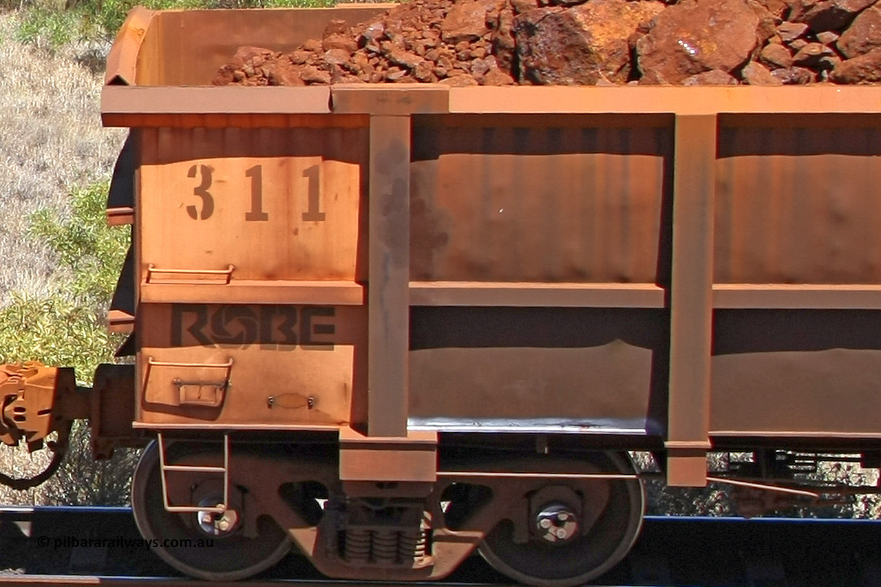 0311 081209 0151
Robe River ore waggon 311, built by Nippon Sharyo Nihon, rotary coupler end plate view, shows new type waybill holder, at the 7 km location just south of Cape Lambert yard. December 9, 2008.
Keywords: 311;Nippon-Sharyo-Nihon;Robe-ore-waggon;