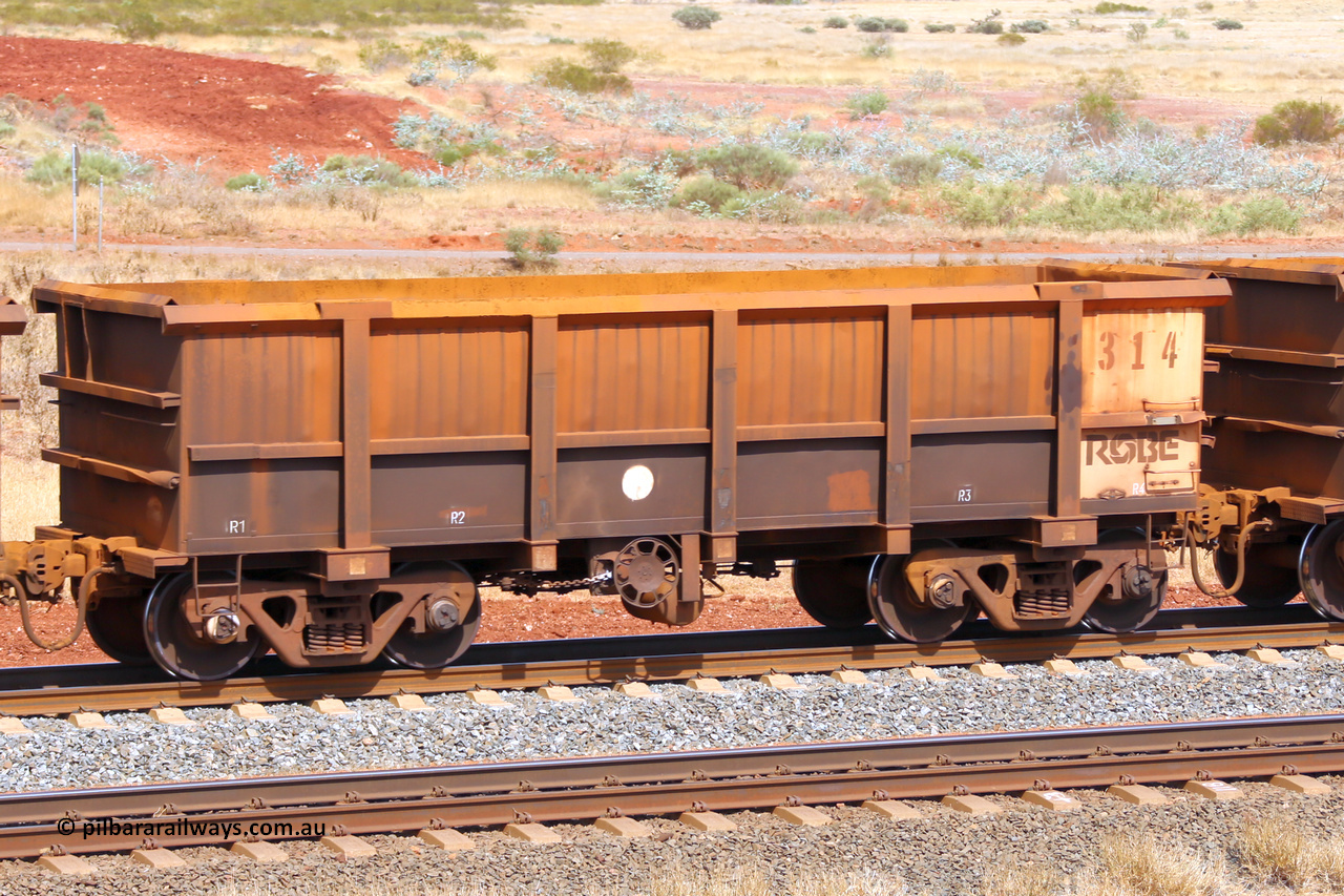 0314 141124 6790
Robe River ore waggon 314, built by Nippon Sharyo Nihon, fixed coupler handbrake side empty view at the 25 km at Arches Siding on the Cape Lambert line. November 24, 2014.
Keywords: 314;Nippon-Sharyo-Nihon;Robe-ore-waggon;