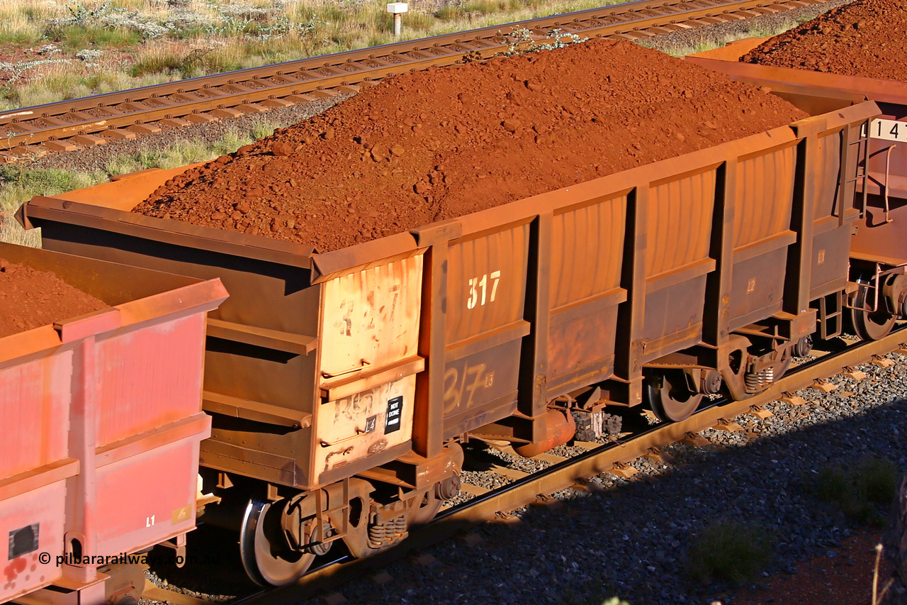 0317 210322 9738
Robe River ore waggon 317, built by Nippon Sharyo Nihon, rotary coupler end non-handbrake side loaded view at the 17 km on the Cape Lambert line, March 22, 2021.
Keywords: 317;Nippon-Sharyo-Nihon;Robe-ore-waggon;