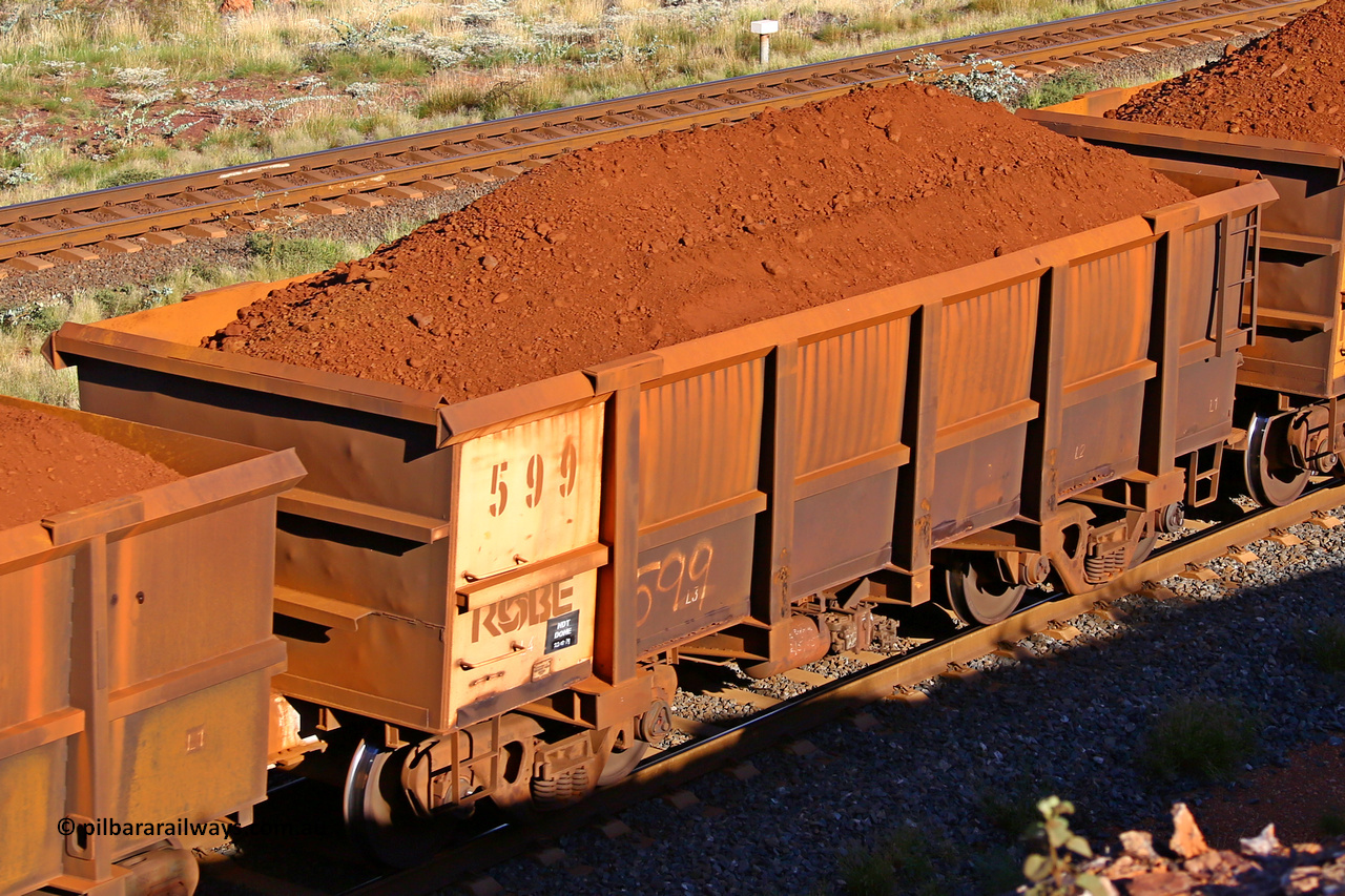 0599 210322 9716
Robe River ore waggon 599, built by Tomlinson Steel WA, rotary coupler end non-handbrake side loaded view at the 17 km on the Cape Lambert line, March 22, 2021.
Keywords: 599;Tomlinson-Steel-WA;Robe-ore-waggon;