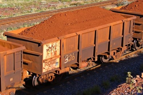0326 210322 9690
Robe River ore waggon 326, built by Nippon Sharyo Nihon, rotary coupler end non-handbrake side loaded view at the 17 km on the Cape Lambert line, March 22, 2021.
Keywords: 326;Nippon-Sharyo-Nihon;Robe-ore-waggon;