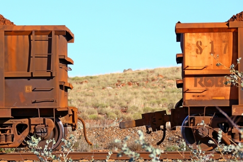 0817 180616 1676
Robe River ore waggon 817, built by Centurion Industries WA, rotary coupler end non-handbrake side loaded view with the pulled fixed coupler from 425 at the 33.7 km, Arches on the Cape Lambert line, June 16, 2018.
Keywords: 817;Centurion-Industries-WA;Robe-ore-waggon;