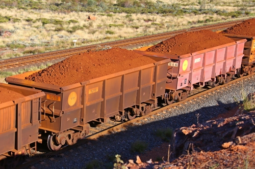 1018-1066 210322 9792
Robe River ore waggon 1018, built by Bradken Rail Qld in December 2005, rotary coupler end non-handbrake side loaded view comparison between painted and unpainted Bradken builds, at the 17 km on the Cape Lambert line, March 22, 2021.
Keywords: 1018;Bradken-Rail-Qld;Robe-ore-waggon;