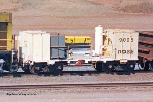 9005 020522 247 04
Robe River compressor waggon 9005, a modified Nippon Sharyo Nihon built waggon with air compressor, grey fuel tank and white air receiver. This style of compressor setup differs greatly from the original compressor waggons built by Nippon Sharyo Nihon. Cape Lambert yard May 22, 2002.
Keywords: 9005;robe-compressor-waggon;