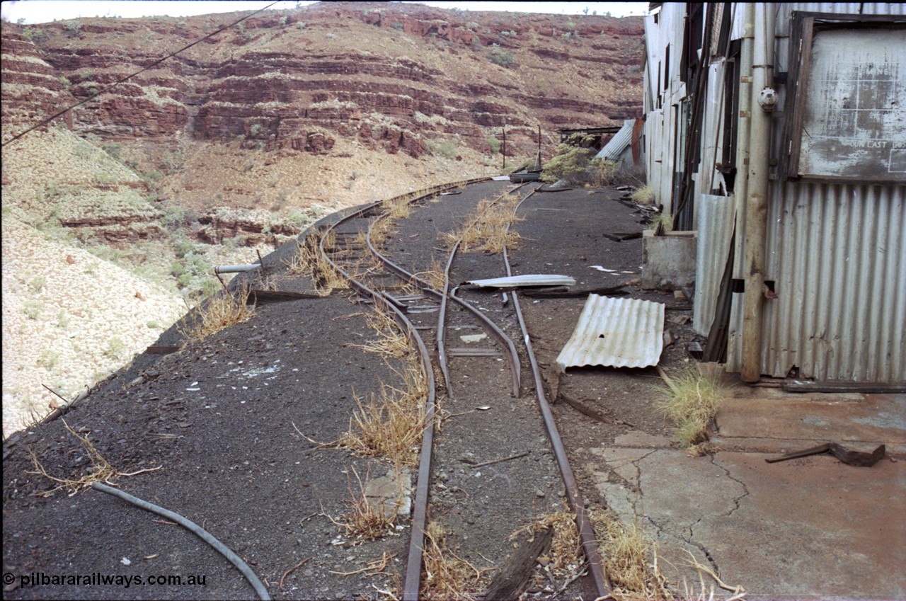 194-10
Wittenoom Gorge, Colonial Mine, asbestos mining remains, view looking south past the underground mining and railway offices with the track running towards the workshops.
