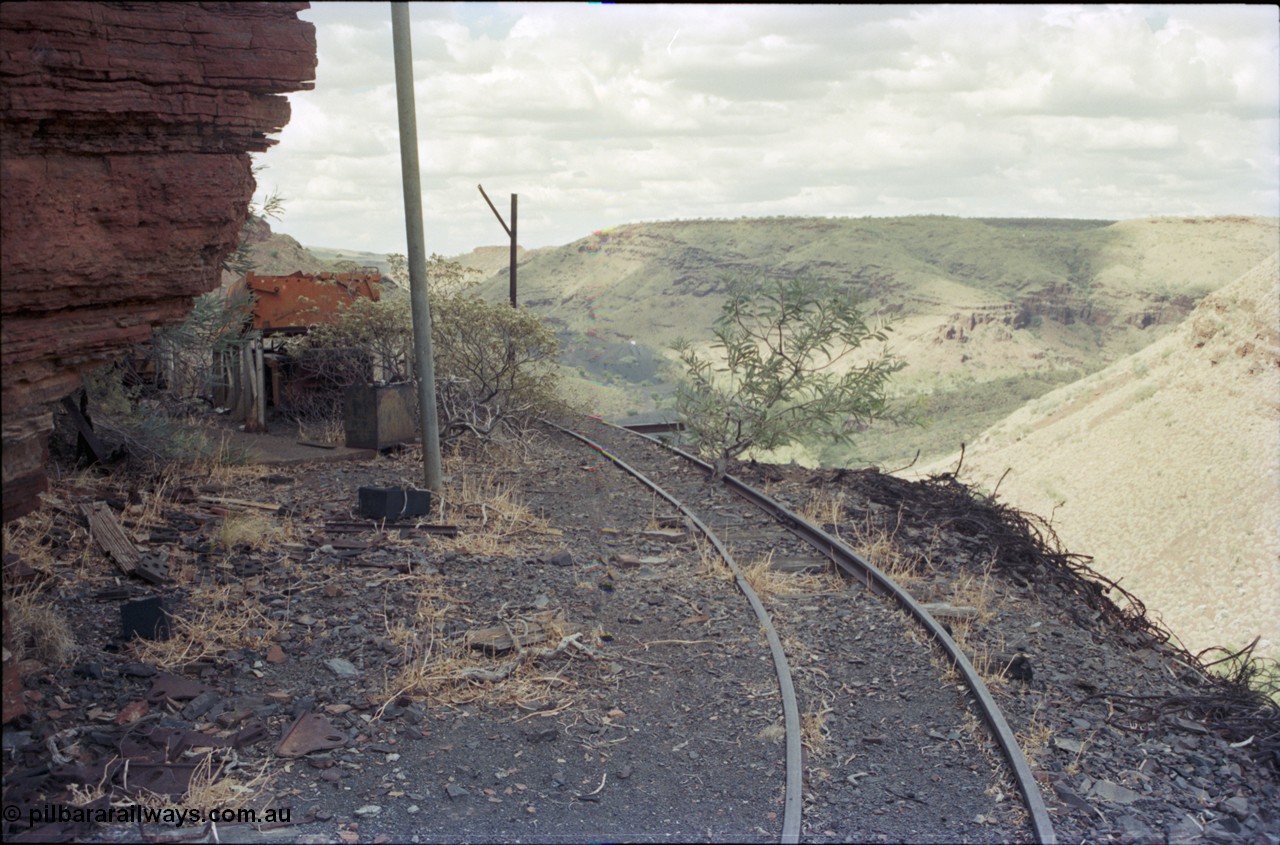 194-16
Wittenoom Gorge, Colonial Mine, asbestos mining remains, view looking north east from storage roads with tracking heading back around to workshops, battery module box visible on ramp.
