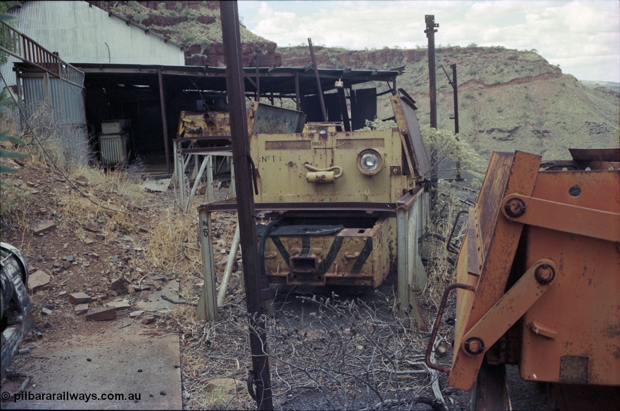 194-17
Wittenoom Gorge, Colonial Mine, asbestos mining remains, view of railway workshop - battery charging plant looking north, Gemco unit at right, English Electric unit with No. 1 battery in front. Catwalk visible in distance.
