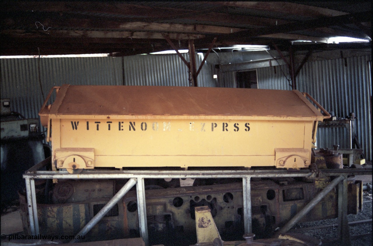 194-20
Wittenoom Gorge, Colonial Mine, asbestos mining remains, battery module over a Mancha hauler, titled WITTENOOM_EXPRSS inside the workshops. This item was relocated to the Pilbara Railways Historical Society museum near 7 Mile Karratha in 2004.
