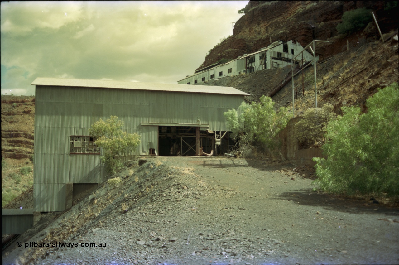 195-37
Wittenoom Gorge, Australian Blue Asbestos or ABA Colonial Mill, view of primary crushing building, shows metal slide chute from upper lever were the waggons are emptied, top building is the underground offices, change rooms etc.
