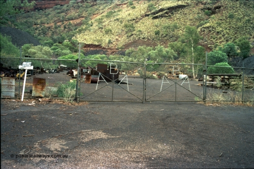 195-23
Wittenoom Gorge, Australian Blue Asbestos or ABA Colonial Mill, view of the gates on the warehouse fenced yard.
