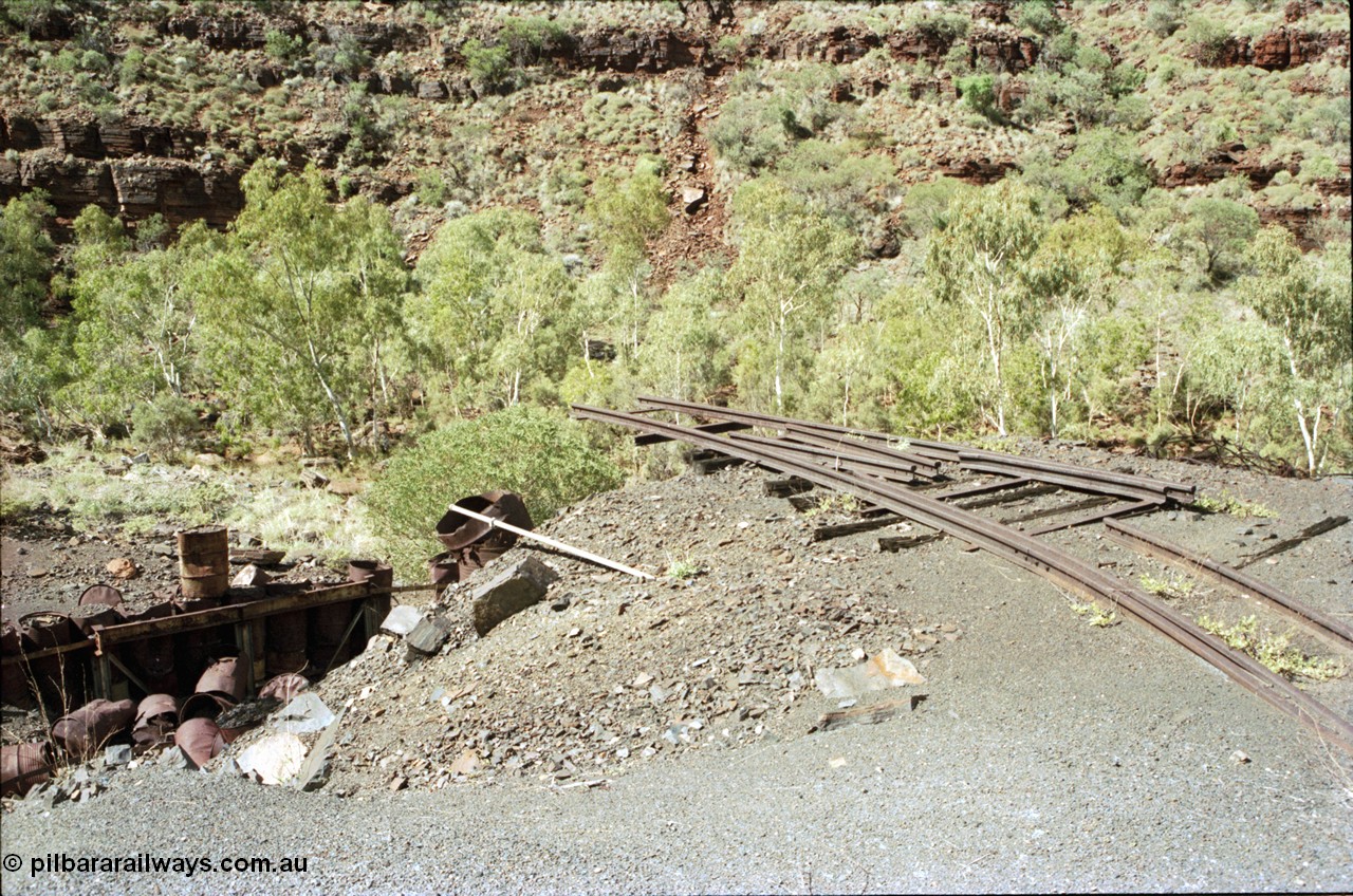 196-30
Wittenoom Gorge, Gorge Mine area, asbestos mining remains, view of demolished building with railway tracks in air, site of former dump or unloading station.
