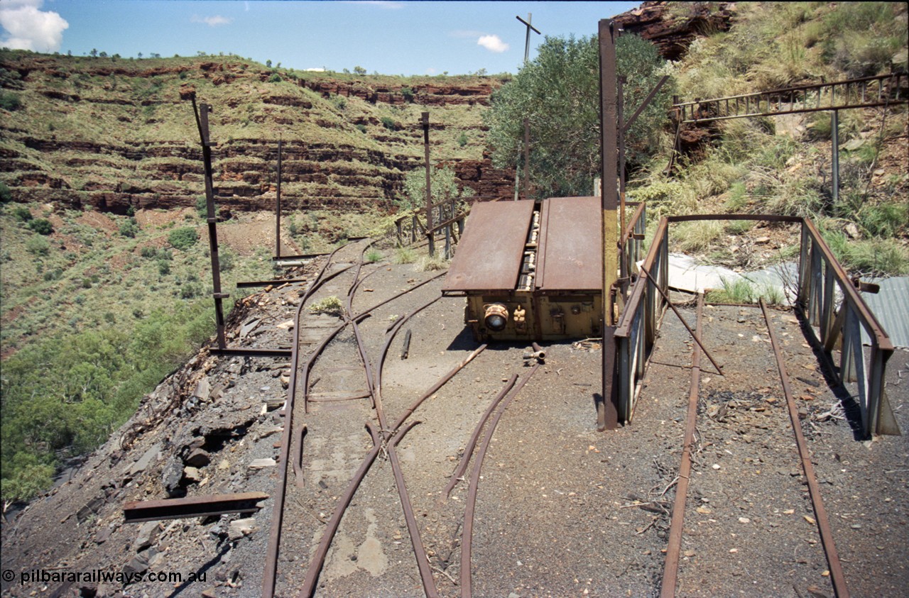 197-12
Wittenoom, Colonial Mine, asbestos mining remains, view looking south of the battery charging shed remains, battery off-take ramps and a battery module are visible along with the shed posts.
