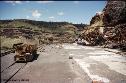 197-19
Wittenoom, Colonial Mine, asbestos mining remains, view looking south east with the demolished underground shit offices and workshops, Mancha battery locomotive #4 and the battery charging shed remains just visible in the distance.
Keywords: Mancha;